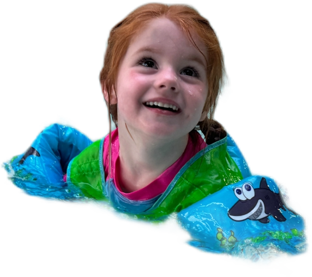 Mia smiling while sitting in a pool in her floaties